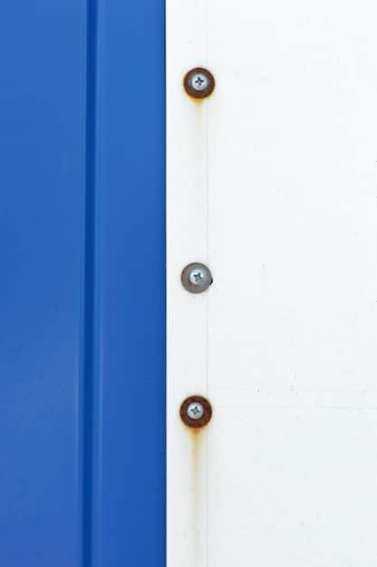A close-up of a reinforced door frame with a heavy-duty strike plate and long screws. The door is also equipped with a high-security deadbolt lock. The image emphasizes the strength and durability of the reinforced entry point.