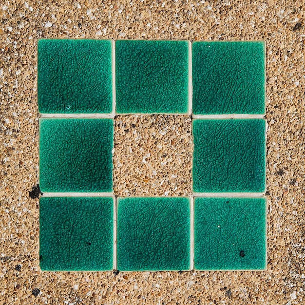 A close-up displaying a variety of patio pavers, including different colors, shapes, and textures, arranged on a display board.