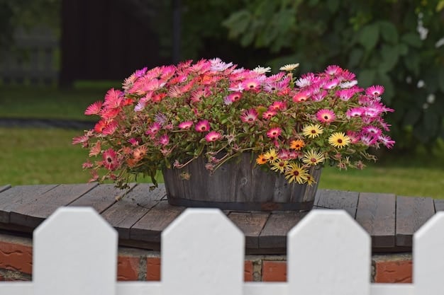 A well-maintained front yard with lush green grass, colorful flowerbeds, trimmed shrubs, and a welcoming front porch with potted plants.