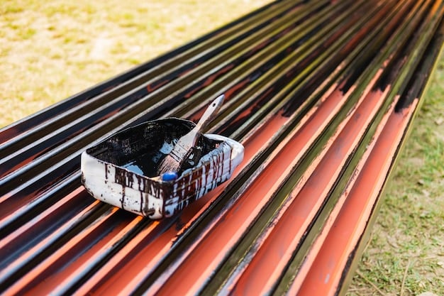 A collection of gutter cleaning tools neatly arranged on a tarp, including a sturdy ladder, gloves, a gutter scoop, a garden hose with a spray nozzle, safety goggles, and a bucket.