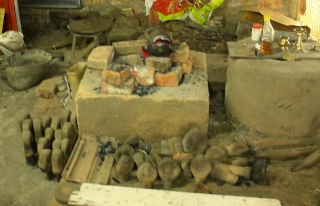 A close-up shot of different types of inexpensive materials that can be used to build a fire pit, such as concrete blocks, paving stones, gravel, and fire-resistant bricks.