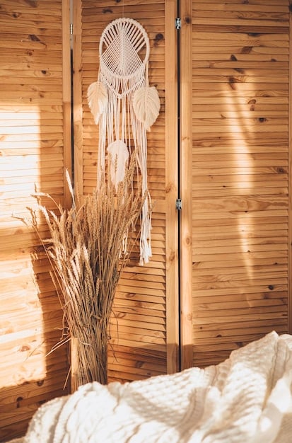 A cozy bedroom featuring a wooden headboard, linen bedding, a rattan rug, and a woven basket for storage, highlighting the use of natural materials and textures to create a warm and inviting biophilic design.