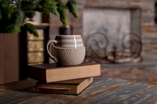 A close-up shot of a beautifully styled coffee table featuring a mix of hardback books, a metallic tray holding small decorative objects, and a small vase with fresh flowers. The arrangement is elegant and well-balanced, showcasing a variety of textures and heights.