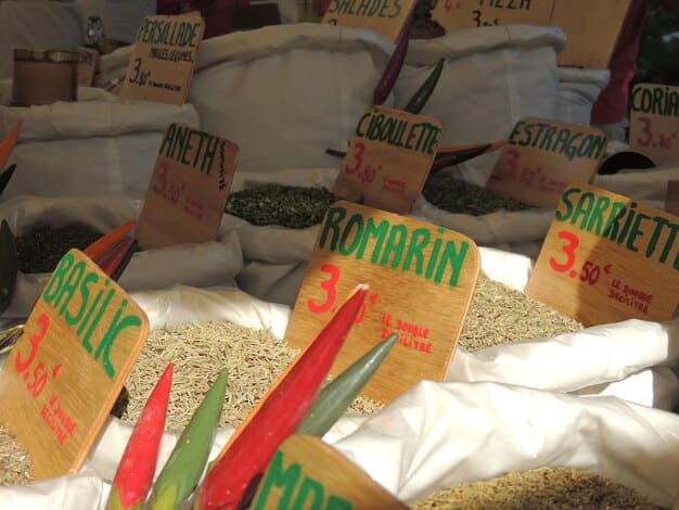 Bags of winterizing fertilizer on display at a garden center. The bags are labeled with NPK ratios emphasizing potassium.